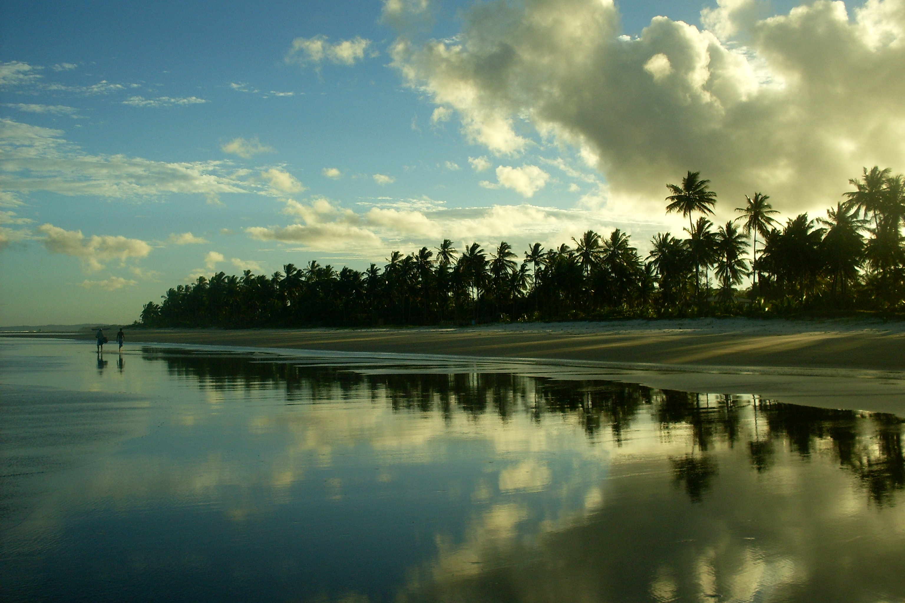 Sunset of a Brazilian beach, with the sky reflected on the water.