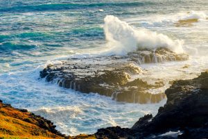 Wave crashing on rocks.