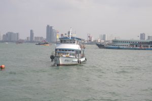 Ferry boat in the harbor of a large city.