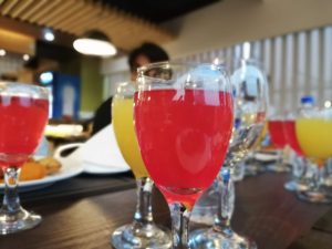 Brightly colored juices in stemware.
