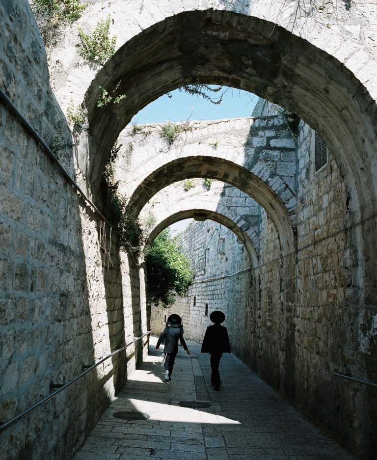 Two kids on the arch-covered St. James Street in Jerusalem.