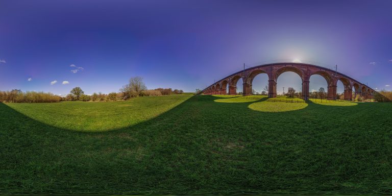 Twemlow Viaduct railway bridge in Holmes Chapel, Cheshire. A Grade II Listed Building (No. 1231669). Crosses the River Dane. Built in 1841, 23 arches. Panoramic image.