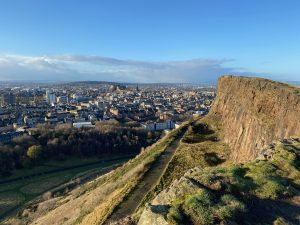View along Salisbury Crags, in Holyrood Park, Edinburgh, overlooking the rest of the city and castle.
