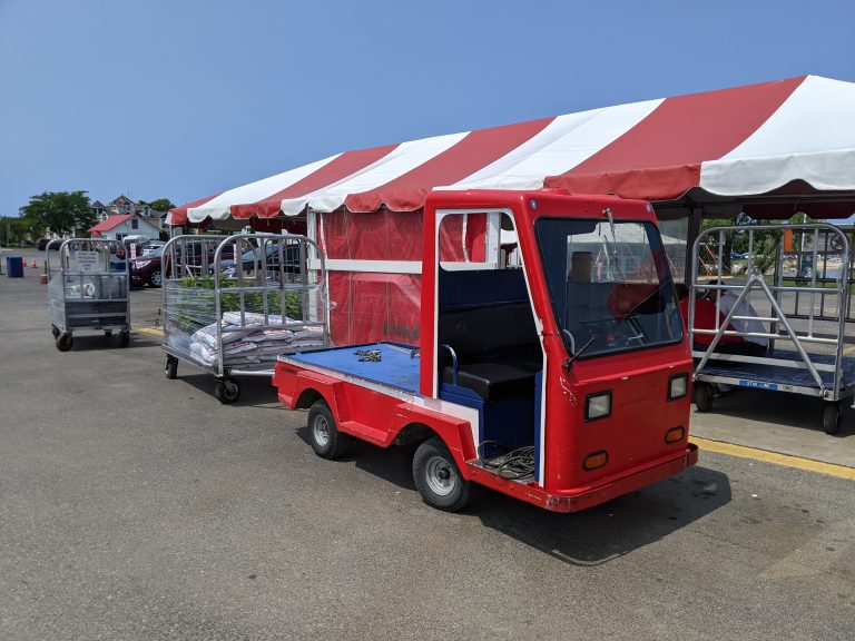 Little red luggage truck that hauls luggage for the Mackinac Island ferry in Michigan.