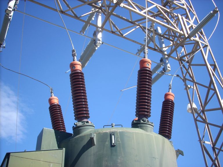 Insulators on top of a large oil filled transformer in an electrical substation