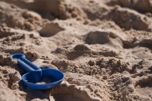 Kids toy shovel on the sands of a beach