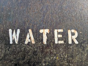 Roughly painted sign saying "Water"