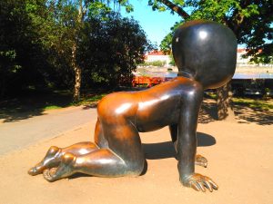 Brass statue of a crawling baby