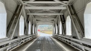 Road through an old white covered bridge