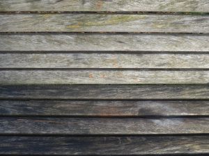 Close-up of a wooden bench with weathered planks
