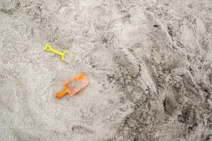 Shovels laying in the sand at the beach