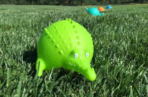 Plastic Animal Toys Sitting In The Grass For Playtime