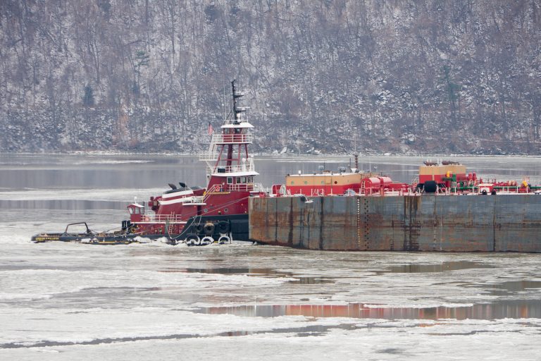 Tugboat and barge on the icy Hudson River