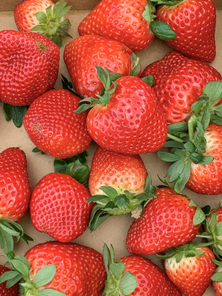 Top view of strawberries in a cardboard box