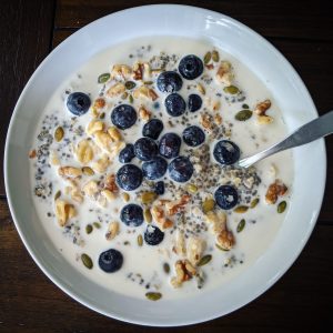 Steel-cut oats and chia seed porridge with blueberries, walnuts, pepitas, maple syrup, and oat milk.
