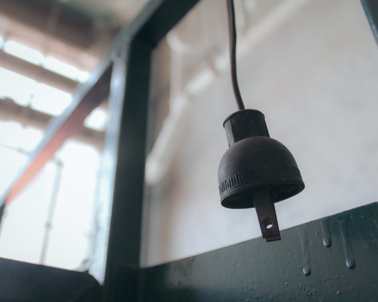 Old power cord hanging from ceiling