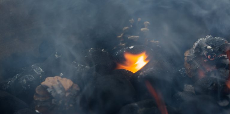 charcoal and pinecones burning and smoking