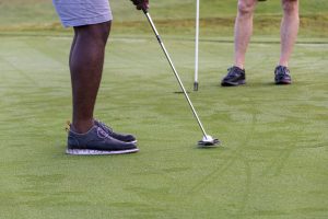 View larger photo: Golfers putting