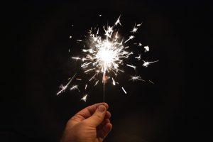 Single sparkler firework at night