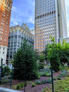 Three tall buildings behind a park in Downtown Pittsburgh