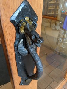 Door handle shaped like a dragon