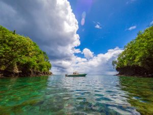 Boat floating between two islands in Martinique