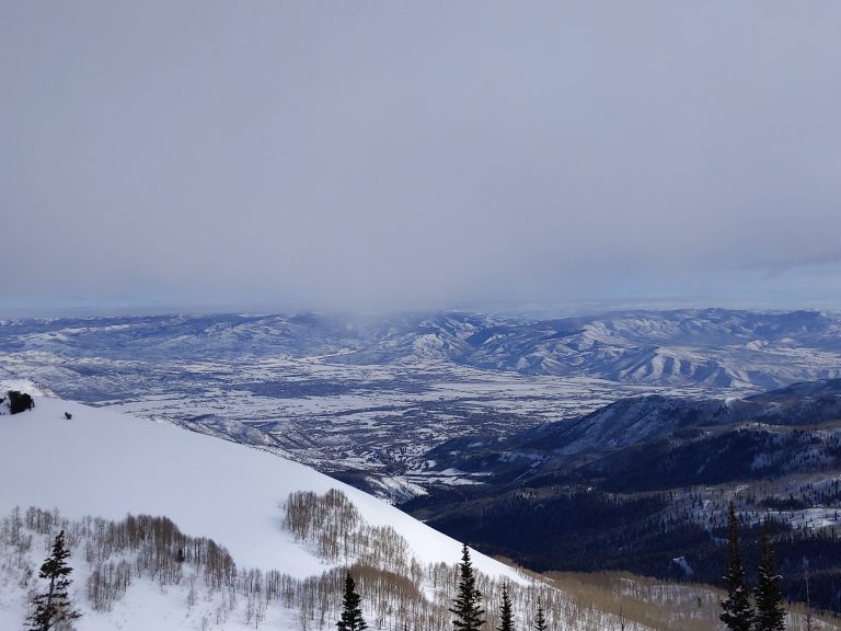 A snow-covered valley in Utah seen from above.