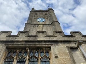 Looking up at a church tower with clock