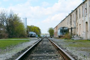 Railroad tracks behind abandoned factory