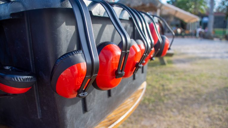 Ear protection headsets hanging from a basket