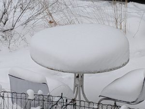 Snow covered table and chairs