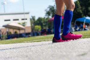 View larger photo: Pink soccer (football) cleats and blue socks