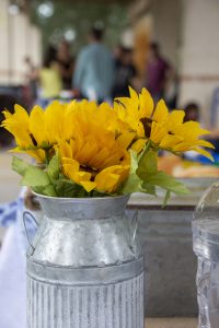 Fake sunflowers in an aluminum vase