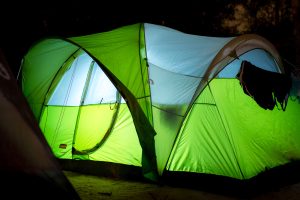 Camping tent illuminated at night