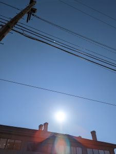 The sun rising over some houses