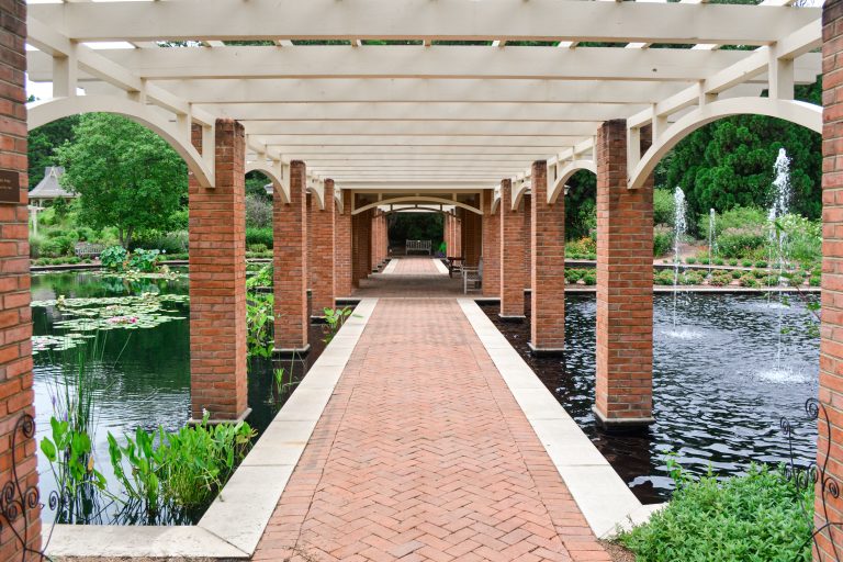 Garden gazebo over a pond with fountains