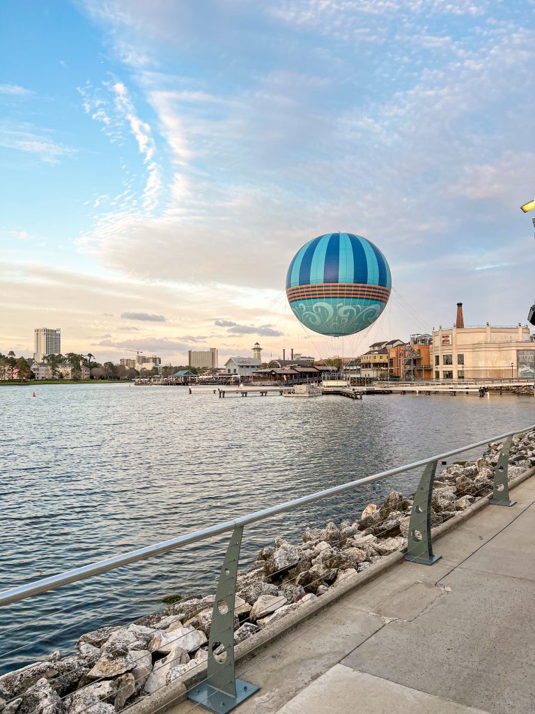 Hot air balloon on the ground by a lake