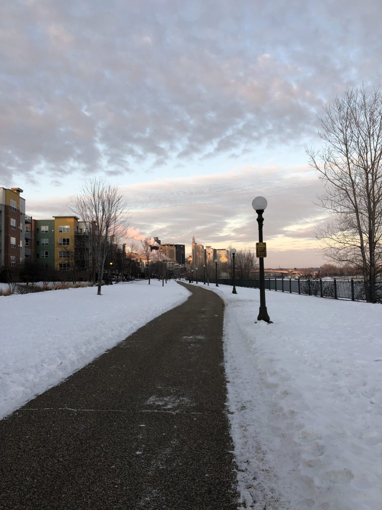 Evening sunset view of a street with city skyline in background (Twin Cities)