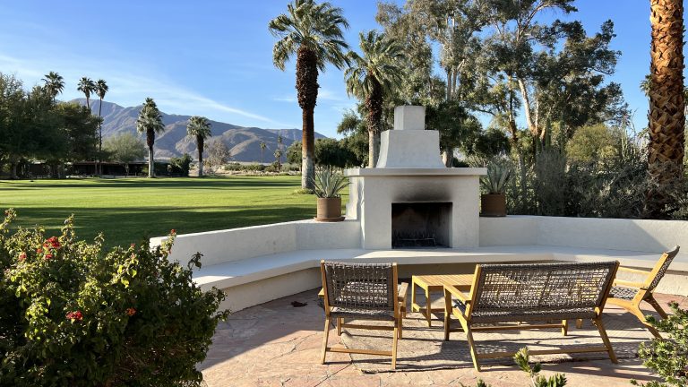 Outdoor living space with fireplace on California desert golf course