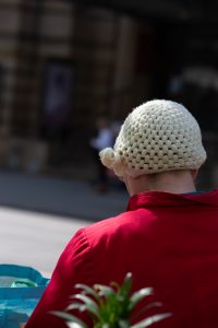 wool hat woman reading lonely