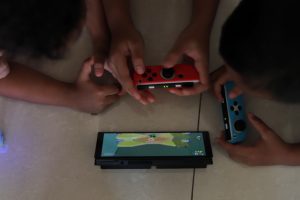 View larger photo: kids playing nintendo switch together