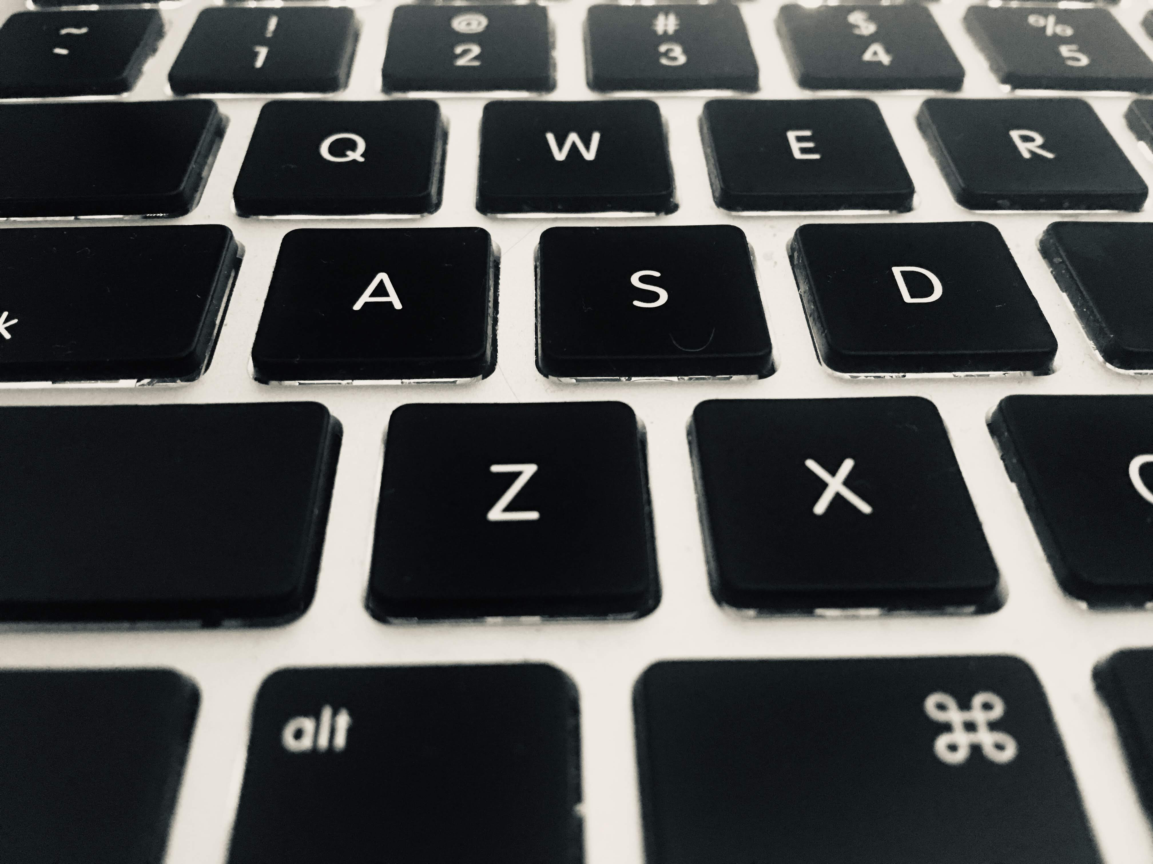 Close-up photograph of a black keyboard with white letters.