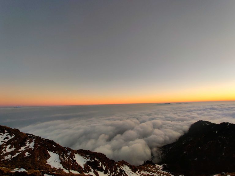 Stunning view of sunset above from cloud.