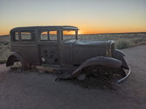 Old vehicle and a desert sunset. 1932 Studebaker on Old Route 66 near Holbrook Arizona, Petrified Forest National Park

