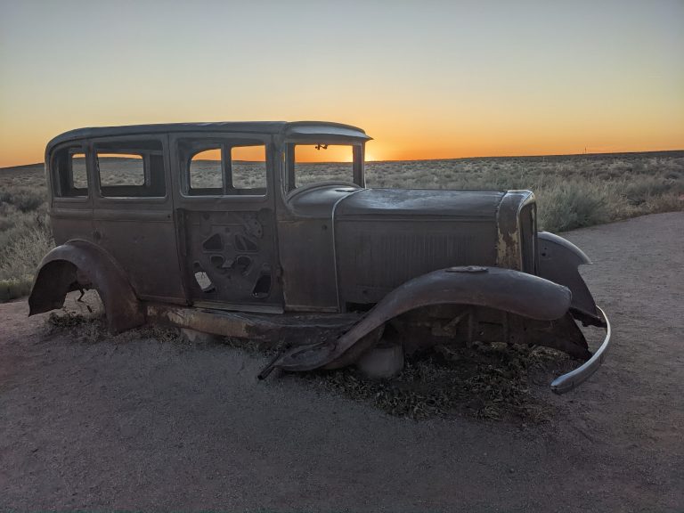 Old vehicle and a desert sunset. 1932 Studebaker on Old Route 66 near Holbrook Arizona, Petrified Forest National Park