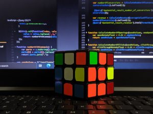 Rubik’s Cube with code background
