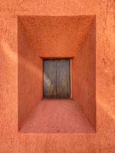 Small window on the orange wall