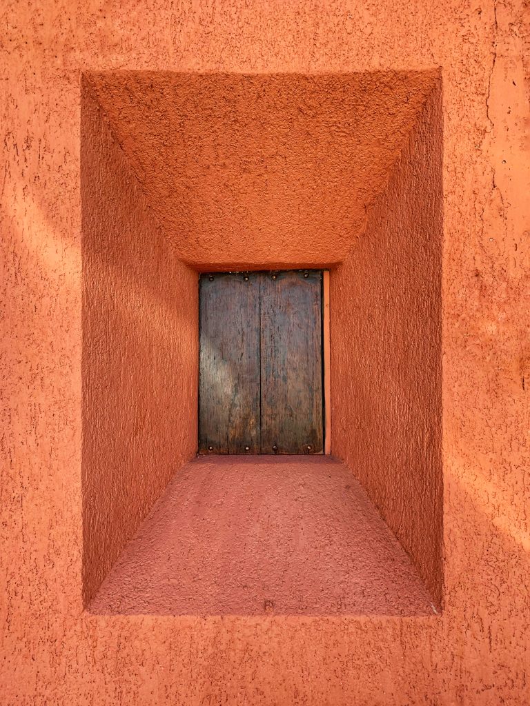 Small window on the orange wall