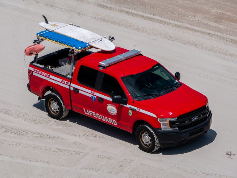 Volusia County lifeguard truck driving on the beach.