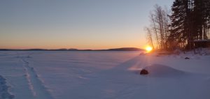 Sunset and snow over frozen lake view